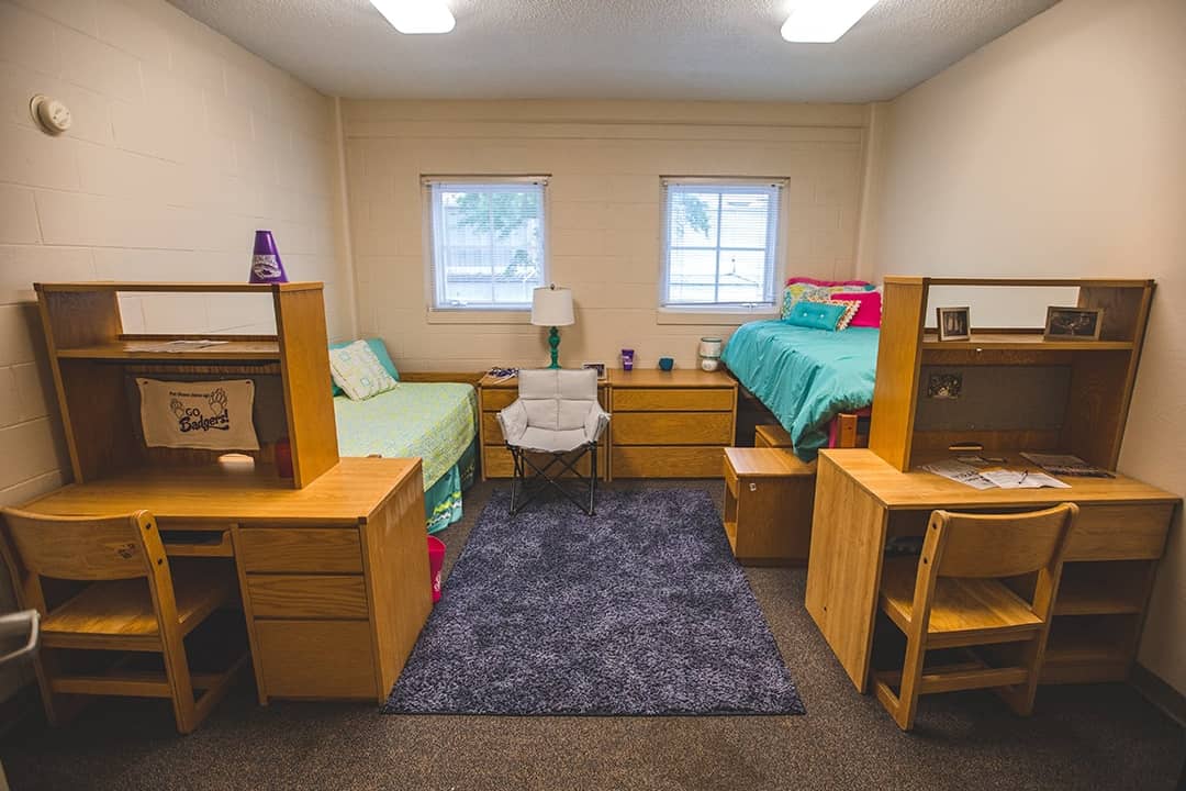 A college dorm room with two single beds.